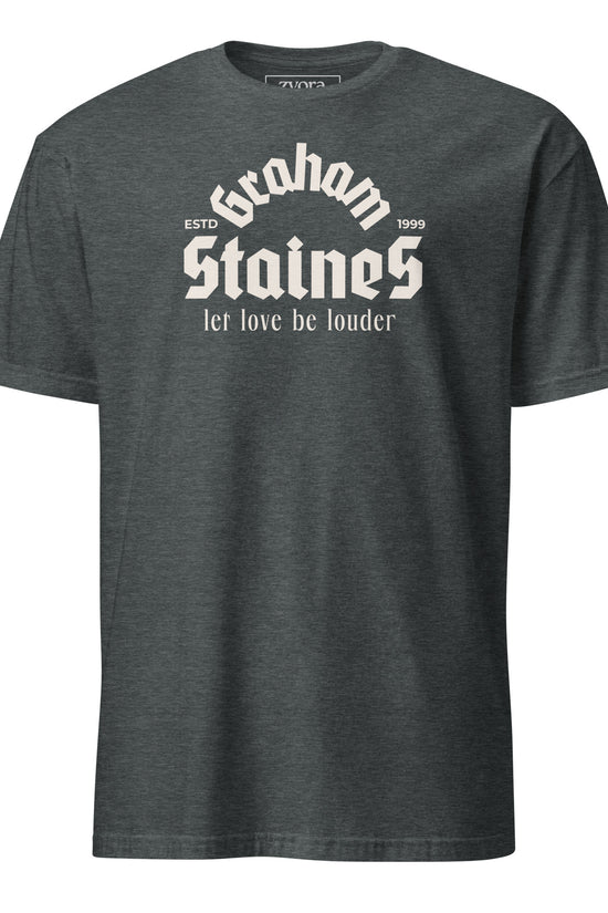 “Graham Staines – Let Love Be Louder” Christian Dark Heather graphic tee, inspired by 1 Corinthians 13:13. Faith-based gift, scripture-inspired apparel for men and women.