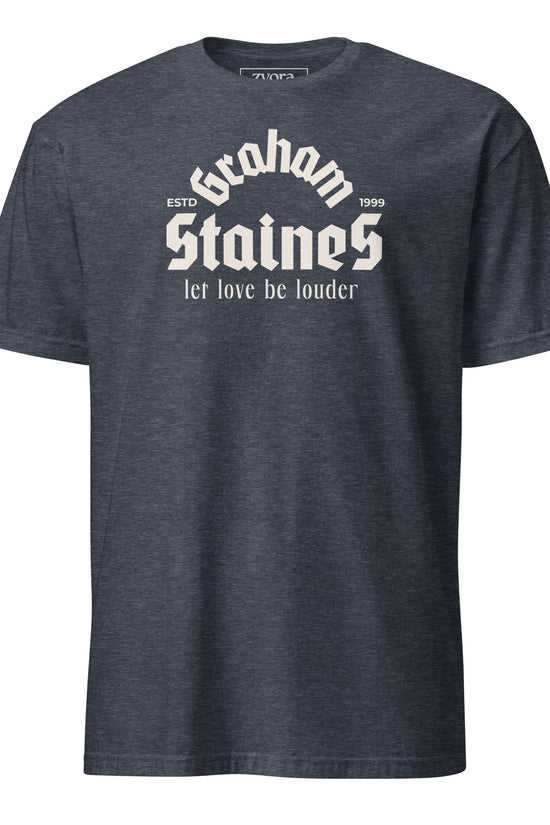“Graham Staines – Let Love Be Louder” Christian Heather Navy graphic tee, inspired by 1 Corinthians 13:13. Faith-based gift, scripture-inspired apparel for men and women.