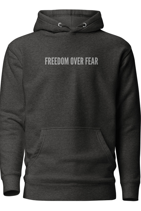 Product mockupUnisex premium Christian hoodie with “Freedom Over Fear” design – faith-based fashion and gift by Zyora Apparel.